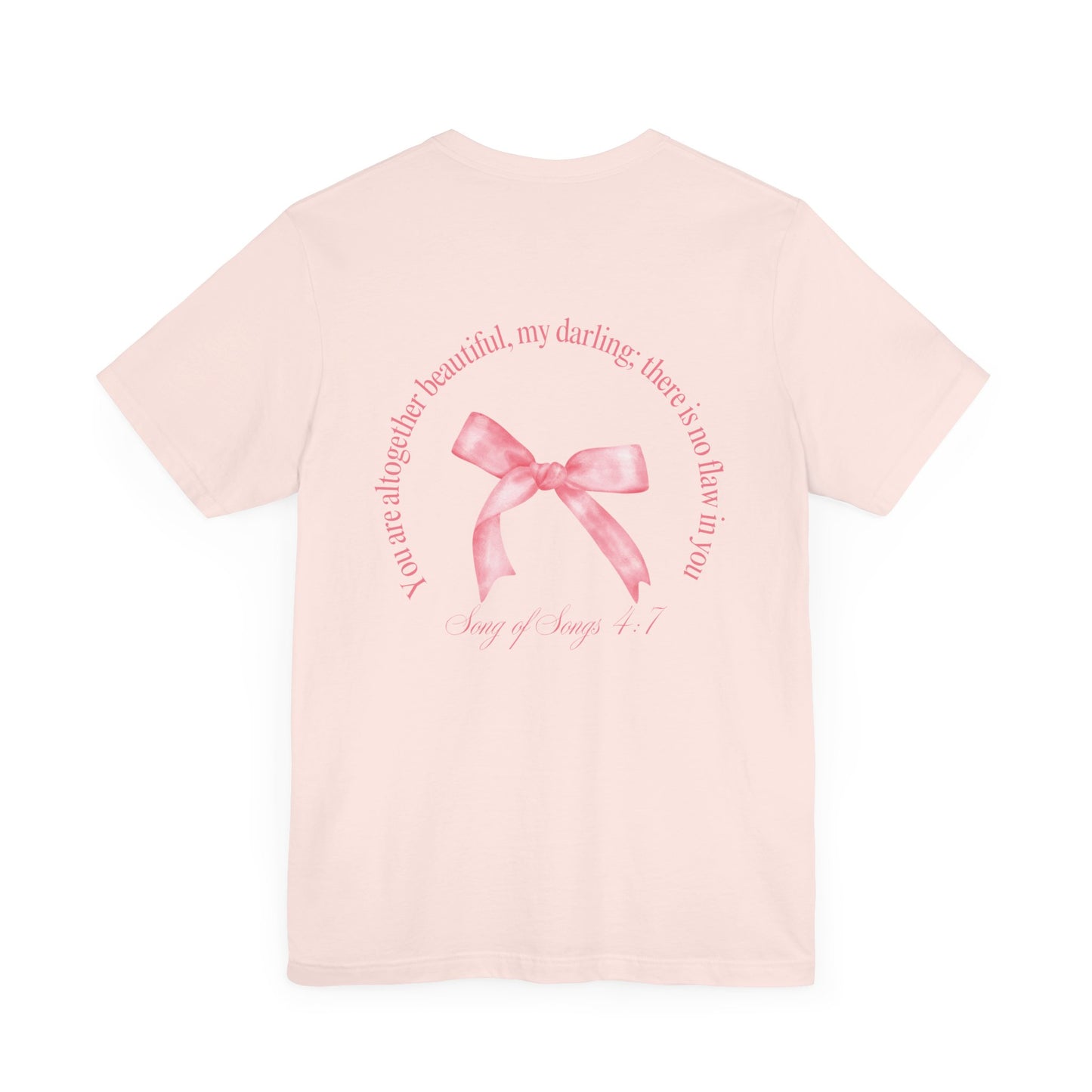 Anfield & Ella Soft Pink "Altogether Beautiful" Tee. The back of the shirt says "You are altogether beautiful, my darlin; there is no flaw in you. Song of Songs 4:7" A pink bow is in the center of the verse.